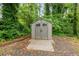 A well-maintained shed provides ample storage space in the lush, private backyard at 211 Caboose Ln, Woodstock, GA 30189