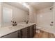 Well lit bathroom features a double sink vanity with modern fixtures and a tub with shower at 257 Pinewood Dr, Covington, GA 30014