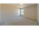 Neutral bedroom features soft carpet, and a window allowing plenty of natural light at 257 Pinewood Dr, Covington, GA 30014