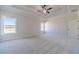Bright and airy bedroom with large windows offering scenic views, complemented by neutral tones and a ceiling fan at 257 Pinewood Dr, Covington, GA 30014