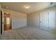 Neutral bedroom features soft carpet and a doorway leading to other rooms of the house at 257 Pinewood Dr, Covington, GA 30014