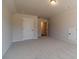 Spacious bedroom features soft carpet, and doors to other rooms of the house at 257 Pinewood Dr, Covington, GA 30014