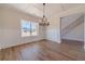 Elegant dining room featuring hardwood floors, wainscoting, large windows, and a chandelier at 257 Pinewood Dr, Covington, GA 30014