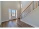 Bright entryway featuring hardwood floors, a staircase, and a front door with glass inserts at 257 Pinewood Dr, Covington, GA 30014