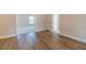 Hallway features hardwood style floors and white baseboards throughout the open space at 257 Pinewood Dr, Covington, GA 30014