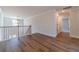 Upstairs landing featuring hardwood style floors, an open railing and a modern light fixture at 257 Pinewood Dr, Covington, GA 30014