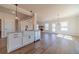 Bright, open-concept kitchen featuring a farmhouse sink, stainless steel appliances, and hardwood floors at 257 Pinewood Dr, Covington, GA 30014