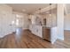 Bright kitchen featuring white cabinets, stainless steel appliances, and hardwood floors at 257 Pinewood Dr, Covington, GA 30014