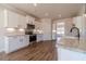 Bright kitchen featuring granite countertops, white cabinets, stainless steel appliances, and hardwood floors at 257 Pinewood Dr, Covington, GA 30014
