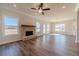 Bright living room features large windows and a brick fireplace, seamlessly connecting indoor and outdoor spaces at 257 Pinewood Dr, Covington, GA 30014