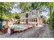 Spacious backyard featuring a beautiful swimming pool, patio, and lush landscaping, creating a private outdoor oasis at 277 Alberta Ne Dr, Atlanta, GA 30305