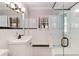 This bathroom features a walk-in shower with glass door, white tile, and a vintage vanity sink at 277 Alberta Ne Dr, Atlanta, GA 30305