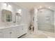 Bathroom with double sinks, granite countertops, modern shower, and tile flooring at 277 Alberta Ne Dr, Atlanta, GA 30305