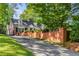 Charming brick home with brick perimeter fence and long driveway at 277 Alberta Ne Dr, Atlanta, GA 30305