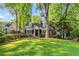 Beautiful brick home with black shutters, dormers, mature trees, and manicured lawn at 277 Alberta Ne Dr, Atlanta, GA 30305