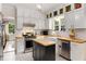 Well-appointed kitchen with white cabinetry, butcher block countertops, stainless appliances, and a mobile island at 277 Alberta Ne Dr, Atlanta, GA 30305