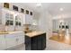 Bright kitchen features white cabinets, farmhouse sink, butcher block counters, and a charming mobile island at 277 Alberta Ne Dr, Atlanta, GA 30305