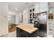 This kitchen boasts white cabinets, butcher block counters, stainless steel appliances, and opens to the dining area at 277 Alberta Ne Dr, Atlanta, GA 30305