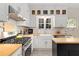 Charming kitchen featuring white cabinetry, butcher block countertops, stainless steel appliances, and subway tile backsplash at 277 Alberta Ne Dr, Atlanta, GA 30305
