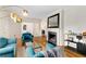 Open-concept living room with fireplace, hardwood floors, and modern decor at 277 Alberta Ne Dr, Atlanta, GA 30305