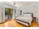 Bedroom featuring a balcony with french doors, hardwood floors and neutral walls at 277 Alberta Ne Dr, Atlanta, GA 30305