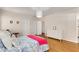 Light and airy bedroom with hardwood floors, neutral walls, and white furnishings at 277 Alberta Ne Dr, Atlanta, GA 30305