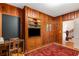 Office with wood-paneled walls, a vintage desk, and built-in bookcase at 277 Alberta Ne Dr, Atlanta, GA 30305