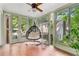 Bright sun room with tile floor, ceiling fan and surrounding glass windows at 277 Alberta Ne Dr, Atlanta, GA 30305