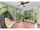 Spacious sunroom with a comfortable hanging chair, tile floor and views of the outdoors at 277 Alberta Ne Dr, Atlanta, GA 30305