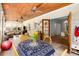 A sunroom is featured with wood ceiling, dining and living space with open doorway to a dining room at 277 Alberta Ne Dr, Atlanta, GA 30305