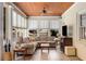 Cozy sunroom with wood plank ceilings, tiled floor, multiple windows, and comfortable seating at 277 Alberta Ne Dr, Atlanta, GA 30305