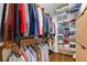 Spacious walk-in closet features wooden shelving, hanging rods, and ample storage space for clothes and accessories at 277 Alberta Ne Dr, Atlanta, GA 30305