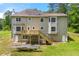 Expansive back exterior of home showing large deck, many windows, and spacious yard at 3060 Robertswood Dr, Powder Springs, GA 30127