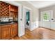 Elegant bar area featuring custom cabinets, wine racks, and a convenient sink for entertaining at 3060 Robertswood Dr, Powder Springs, GA 30127