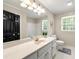 Bathroom features a large mirror, a white vanity, and a shower/tub combo at 3060 Robertswood Dr, Powder Springs, GA 30127