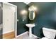 Stylish powder room with a pedestal sink and modern lighting at 3060 Robertswood Dr, Powder Springs, GA 30127