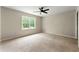 Spacious bedroom features a large window, plush carpeting and neutral paint at 3060 Robertswood Dr, Powder Springs, GA 30127
