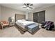 Comfortable bedroom with a ceiling fan, window with blinds, and a tufted headboard bed at 3060 Robertswood Dr, Powder Springs, GA 30127