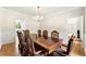 Formal dining room with hardwood floors and elegant chandelier, perfect for Gathering gatherings at 3060 Robertswood Dr, Powder Springs, GA 30127