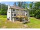 Back of house featuring a wooden deck and lush trees at 3060 Robertswood Dr, Powder Springs, GA 30127