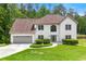 Charming stucco home with a well-manicured lawn and attached two-car garage at 3060 Robertswood Dr, Powder Springs, GA 30127