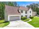 A two-story stucco home with an attached two-car garage and a well-kept lawn at 3060 Robertswood Dr, Powder Springs, GA 30127