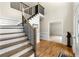 Inviting foyer featuring staircase with stained wood steps and black wrought iron railing at 3060 Robertswood Dr, Powder Springs, GA 30127