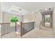 Bright hallway with elegant chandelier and large window showcasing scenic views of backyard at 3060 Robertswood Dr, Powder Springs, GA 30127