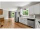 Open-concept kitchen with stainless steel appliances and a seamless transition to the living area at 3060 Robertswood Dr, Powder Springs, GA 30127