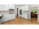 Spacious kitchen featuring modern appliances, white cabinetry, and hardwood flooring at 3060 Robertswood Dr, Powder Springs, GA 30127