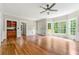 Large living room with a wet bar, hardwood floors, and multiple windows at 3060 Robertswood Dr, Powder Springs, GA 30127