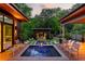 Beautiful backyard with a pool, spa, lounge chairs and wooden deck offering a relaxing retreat at 3740 Powers Ferry Nw Rd, Atlanta, GA 30342