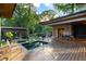 Outdoor living space featuring a deck, pool, spa, lush landscaping, and modern architecture at 3740 Powers Ferry Nw Rd, Atlanta, GA 30342