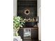 Home bar featuring a dark tile backsplash, wood shelf with liquor bottles, and a stainless steel beverage cooler at 3740 Powers Ferry Nw Rd, Atlanta, GA 30342